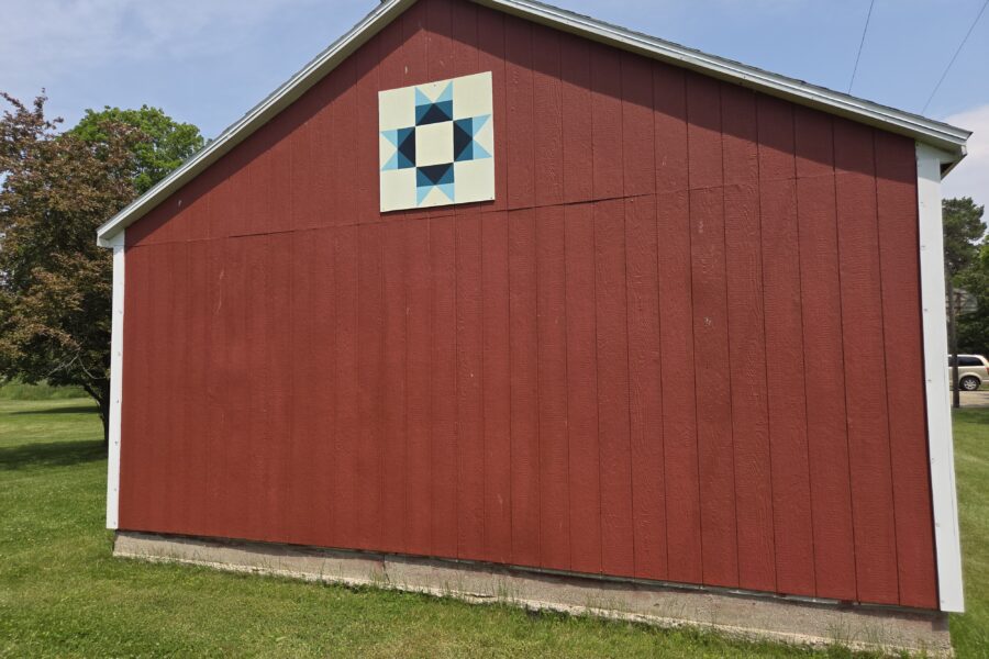 Red barn with a geometric quilt design.